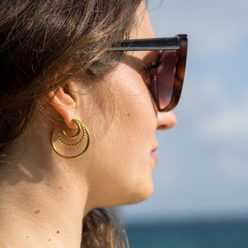 Triple hoop earrings on model